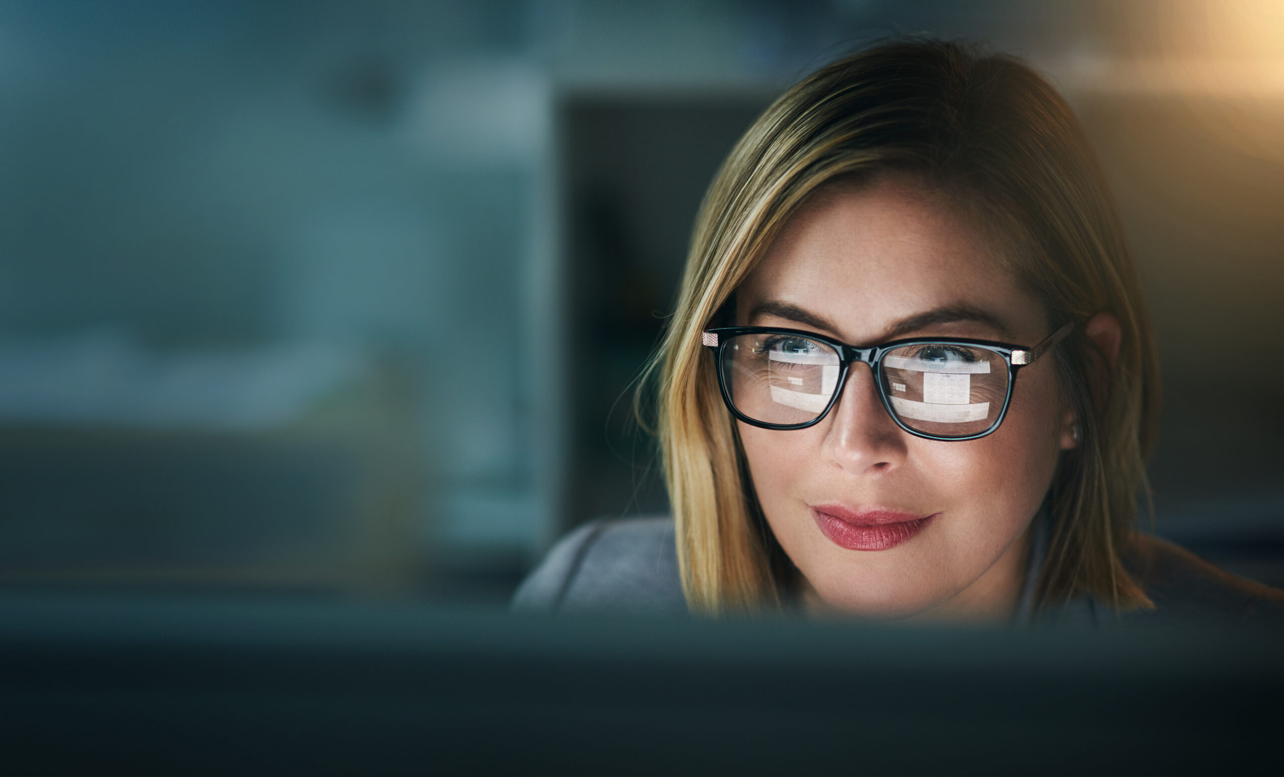 Glasses, serious and business woman at night on a computer or working late or editor for a project deadline and in an office. Research, email and overtime or corporate worker or analysis and on pc